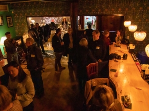 people talking at a bar