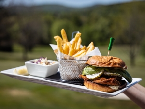 Holding a burger and fries plate