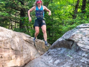 woman scaling boulders